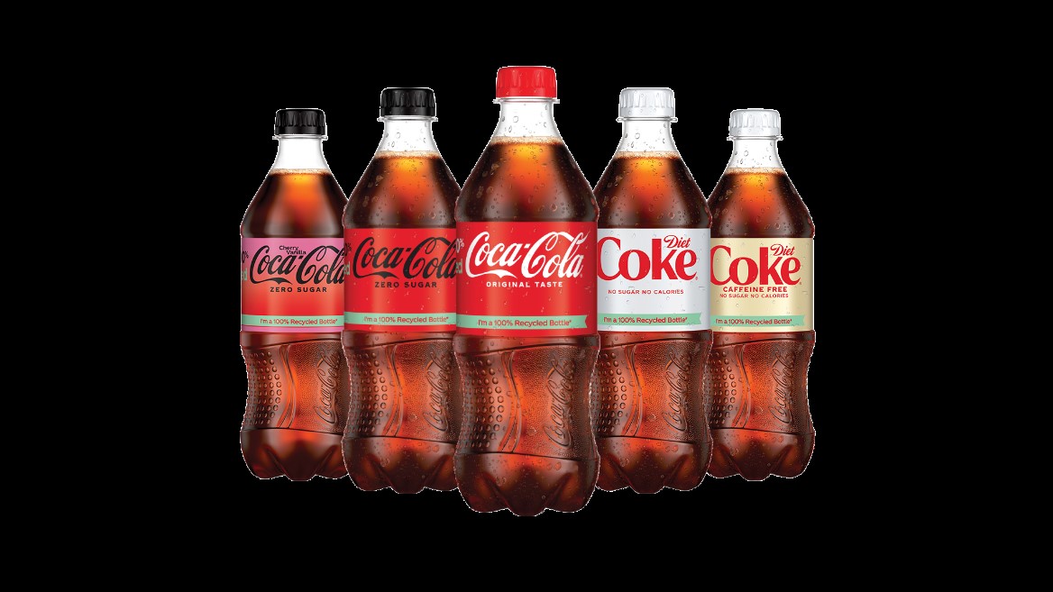 Coca Cola bottles against a black background.