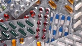 Stack of different pills in blister packs.