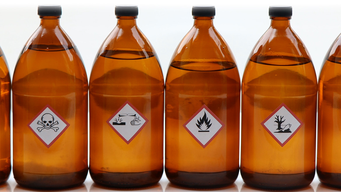 Warning symbols for chemical hazards on chemical containers.